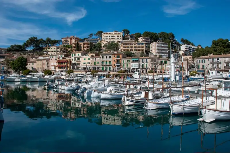 Sailing boats and fishing boats in harbor of Port de Sóller on Spanish island Mallorca