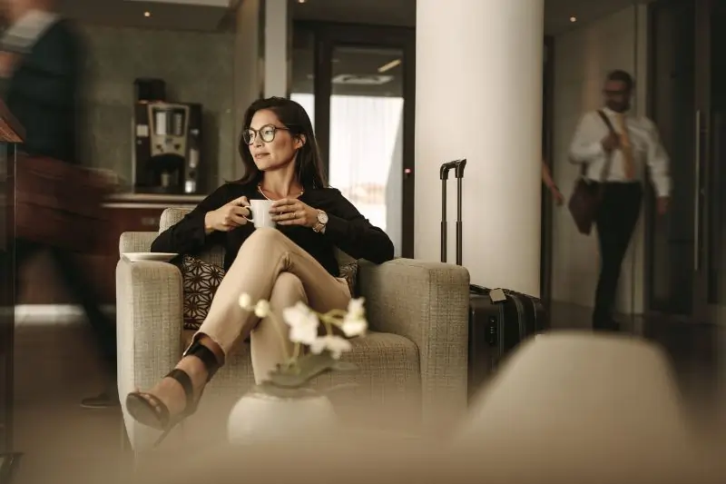 Woman Having Coffee in the Airport Lounge 